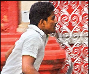 THEN AND NOW: Bharathikannan, a third year student of the Dr Ambedkar Law College, with a knife in his hand on the college premises on Wednesday; and
