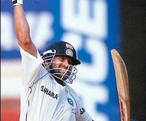 Sachin Tendulkar exults after scoring a century at the first Test between India and England at MAC Stadium in Chennai on Monday.
