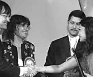 FIPRESCI jury chairman Chris Fujiwara congratulating Anjali Menon after she received the FIPRESCI award for her film `Manjadikkuru'.