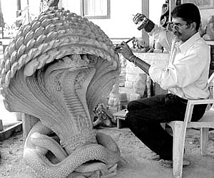 Kiran Subbaiah sculpting a serpent God in Mysore on Wednesday.