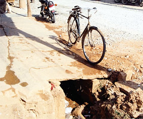An apology for a footpath and a road that has not been asphalted properly. Such sights are common in K R Puram constituency