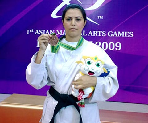 Gul-e-Surkhab, Jammu and Kashmir's ace martial art champion, displays her bronze medal she won in first Asian Martial Games in Bangkok. (IANS)