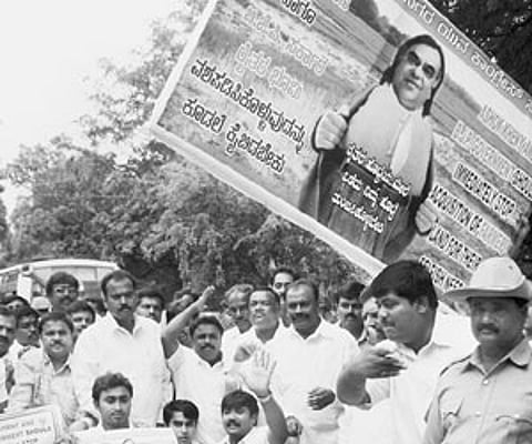 Congress workers staging a protest against land acquisition for NICE project in Bangalore on Thursday.