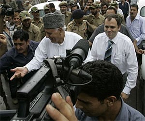 Omar Abdullah accompanied by his father Farooq, leaves for the Governor's office in Srinagar, July 28. (AP)