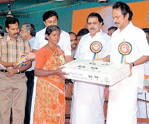 Local Administration Minister M K Stalin distributing free stove to a beneficiary during the inauguration of Tirupur district on Sunday.
