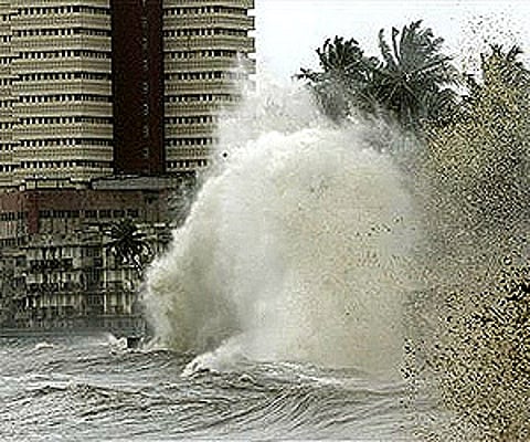 A huge wave hits the safety wall of the buildings along the sea shore during high tide in Mumbai. (Photo: AP)