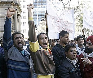 Indian students hold protest signs during a rally to stamp out violence against international students and racism in Sydney. AP