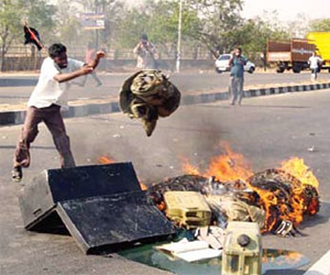 Supporters of Sri Lankan Tamils burning the clothes of Armymen in Coimbatore on Saturday alleging that the Army was carrying arms for Sri Lanka