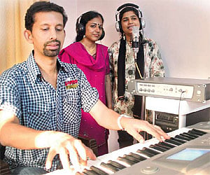 Alex Paul at a recording session with singers Sangeeta Balachandran and S. Anita.