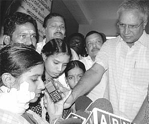 Chief Minister K.Rosaiah enquiring with Anusha about her health over phone held by MP Undavalli Arun Kumar at the Government Hospital in Rajahmundry