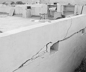Cracks that appeared on the walls following the unearthy sound. (below) Broken pieces of main door at Venkatrami Reddy’s house.