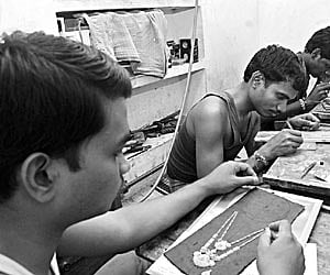 CREATIVITY TO THE FORE: Goldsmiths from West Bengal working at a smithery at Ramakrishnapuram in Coimbatore.