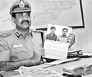 Commissioner of Police (CoP) P Sivanandi showing the photographs of the two accused nabbed in the Akila murder case in Coimbatore on Monday