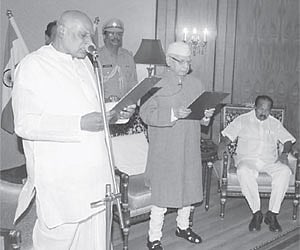Finance Minister Konijeti Rosaiah being sworn in as caretaker Chief Minister of the State by Governor N D Tiwari at Raj Bhavan in Hyderabad.