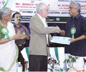 United Nations Resident Coordinator and UNDP resident representative Patrice Coeur-Bizot handing over the certificates to the Forest Minister Binoy V