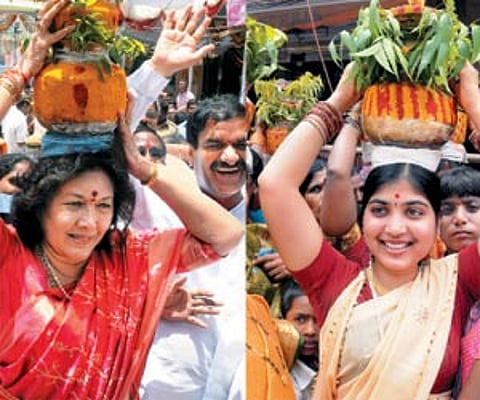 Minister for Tourism (left) and a young woman carry 'bonalu' to offer to goddess Mahankali at Sri Ujjaini Mahankali temple in Secunderabad. ENS