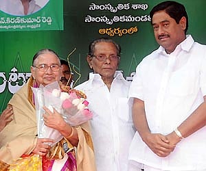Minister for Dharman Prasada Rao Roads Buildings along with Chairman Cultural Council Ramana Murthy felicitating Savitramma wife of late Ghantasala.