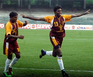 West Bengal footballer Denson Devadas and a team mate celebrate their team's 2-1 win over Punjab during the Santosh Trophy final in Kolkata. PTI
