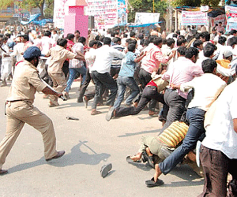 Rising violence: Police caned and dispersed the mob of Telangana activists who attacked buses in Nalgonda district on Monday. | Express Photo