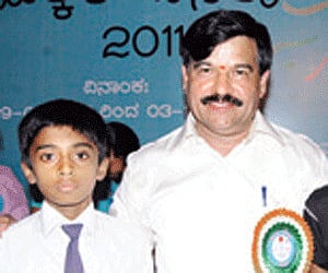 Ramadas with the children whose education he will sponsor | S Udayashankar