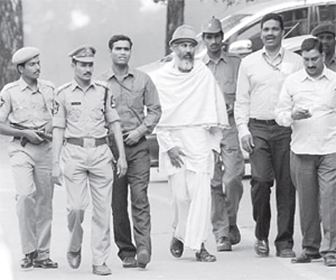 Bharat Bhai (middle), accused in Mecca Masjid blast case, coming out of Nampally court after being produced by NIA officials in Hyderabad on Saturday.