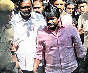 Police escort J K Ritheesh following his arrest | Express