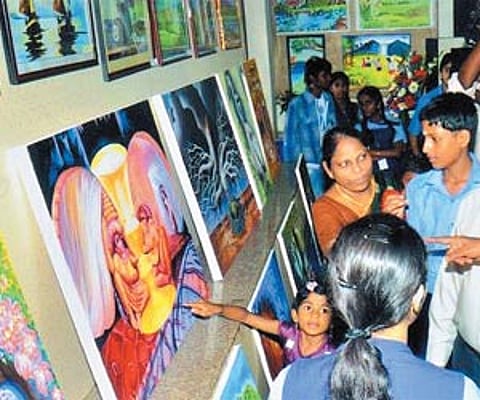 FOR THE LOVE OF MOTHER EARTH: Visitors admiring the work of the children of SBOA School & Junior College, Anna Nagar, at ‘Environex 2011’ an arts and