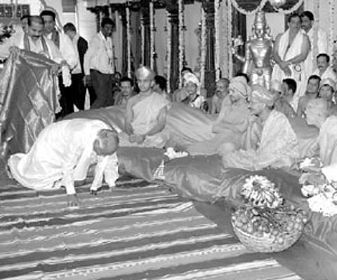 Chief Minister Yeddyurappa seeking blessings of the seers at the Rajangana auditorium.