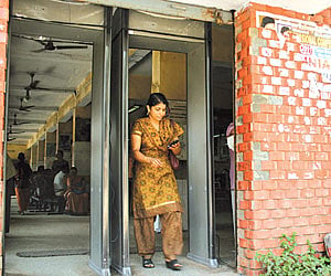 A commuter passing through the metal detector installed at the centre.