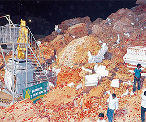 Sta nding test imony: A statue of Sri Krishna Devarayalu stands amid the ruins in Srikalahasti on Wednesday night. (right top) days before the collaps