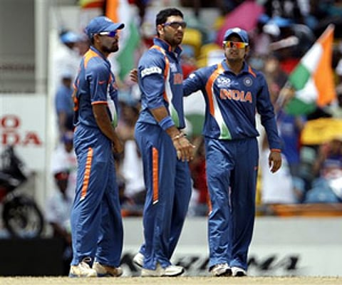 Yuvraj Singh, center, stands with teammates Suresh Raina, right, and Yusuf Pathan. AP Photo