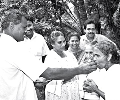 Sharmi’s family members distributing sweets at her house in Balal grama panchayat in Kasargod on Friday.
