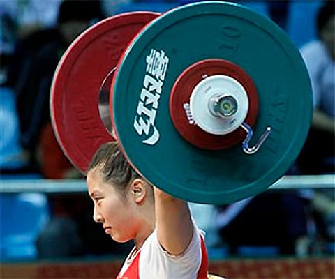 China's Li Ping lifts the weights during women's 53 kg Weightlifting at the16th Asian Games in Guangzhou, China, Sunday. AP Photo