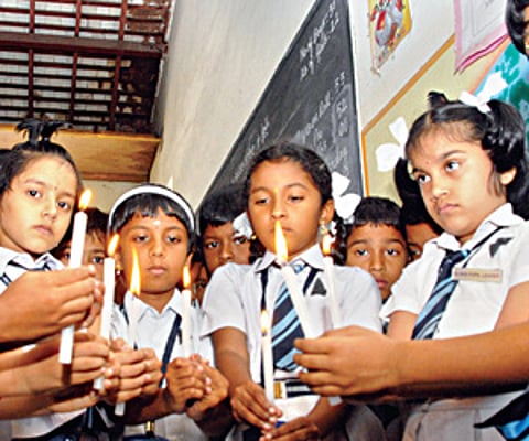 Students of SBOA School at R S Puram in Coimbatore pay homage on Monday to the two children Muskan and Rithik who were murdered.