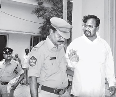 Mallela Om Prakesh being escorted to the court in Anantapur on Wednesday. ENS