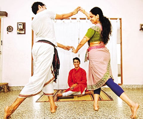 A Lakshmanaswamy watches as his disciples practice a dance sequence