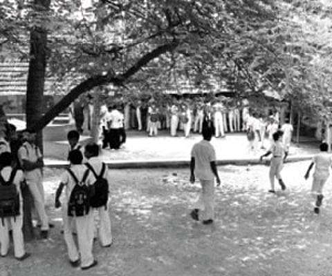 (Above) Students throng the canteen to have their mid-day meal on Wednesday. (Left) The gap in the compound wall on the north-eastern side of the sch