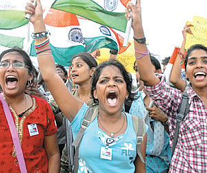 Students raise slogans on the Marina Beach on Wednesday to show their solidarity with Anna Hazare