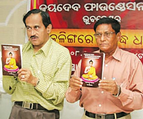State Election Commissioner Ajit Tripathy (Left) releasing a book ‘Where are those stone epigraphs on Ashoka located at Kapileswar?' (Express Photo)