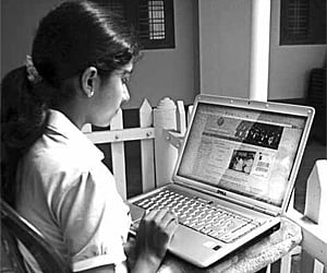 Sreelakshmi Suresh working with her computer at her residence in Chevayoor | Express Photo