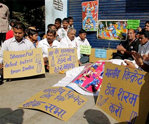 Indian cricket fans hold placards during a protest in Ahmadabad on Saturday after Indian team lost four test match series against Australia. (AP)