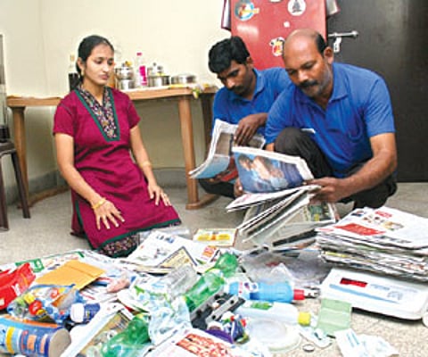 Employees from Kuppathotti.com collecting waste from a client's house | EPS