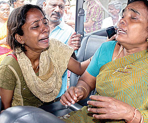 SHED HOPES: Lead fire officer K Anbazhagan’s (L) wife Amudha and daughter Sharmila at the Government General Hospital in the city, Monday.