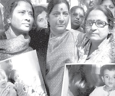 Sushma Swaraj with grandparents of NRI children Aishwarya and Abhigyan during their protest outside the Norwegian Embassy in New Delhi on Monday