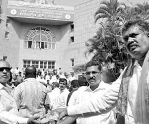 Ramanjaneya (right) distributing sweets outside the BBMP office after his wife Sharadamma was elected as the Mayor | Nagaraja Gadekal