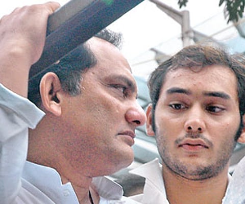Mohd Azharuddin with his elder son Asaduddin during the funeral procession of his younger son Ayazuddin in Hyderabad on Friday. | Express Photo
