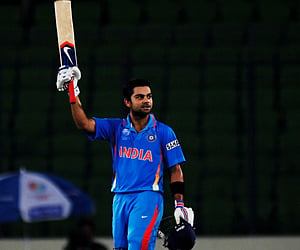 Virat Kohli raises his bat on reaching his century during the opening game of the ICC Cricket World Cup between Bangladesh and India. (Getty Images)