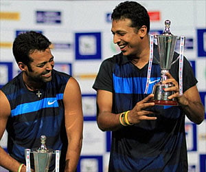Chennai Indian tennis players Leander Paes and Mahesh Bhupathi pose with their trophies after the Chennai Open win. (PTI)