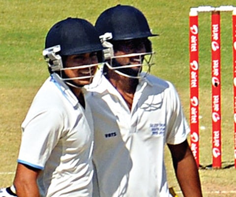 Double centurion Manish Pandey (left) of Karnataka and cenutrion Abhinav Mukund of Tamil Nadu celebrate during their 174-run stand for the third wicke