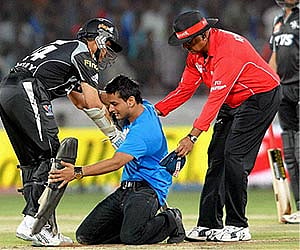 A fan of Sourav Ganguly tries to touch his feet during IPL-4 cricket match between Pune Warriors and Deccan Chargers on Tuesday (PTI photo).